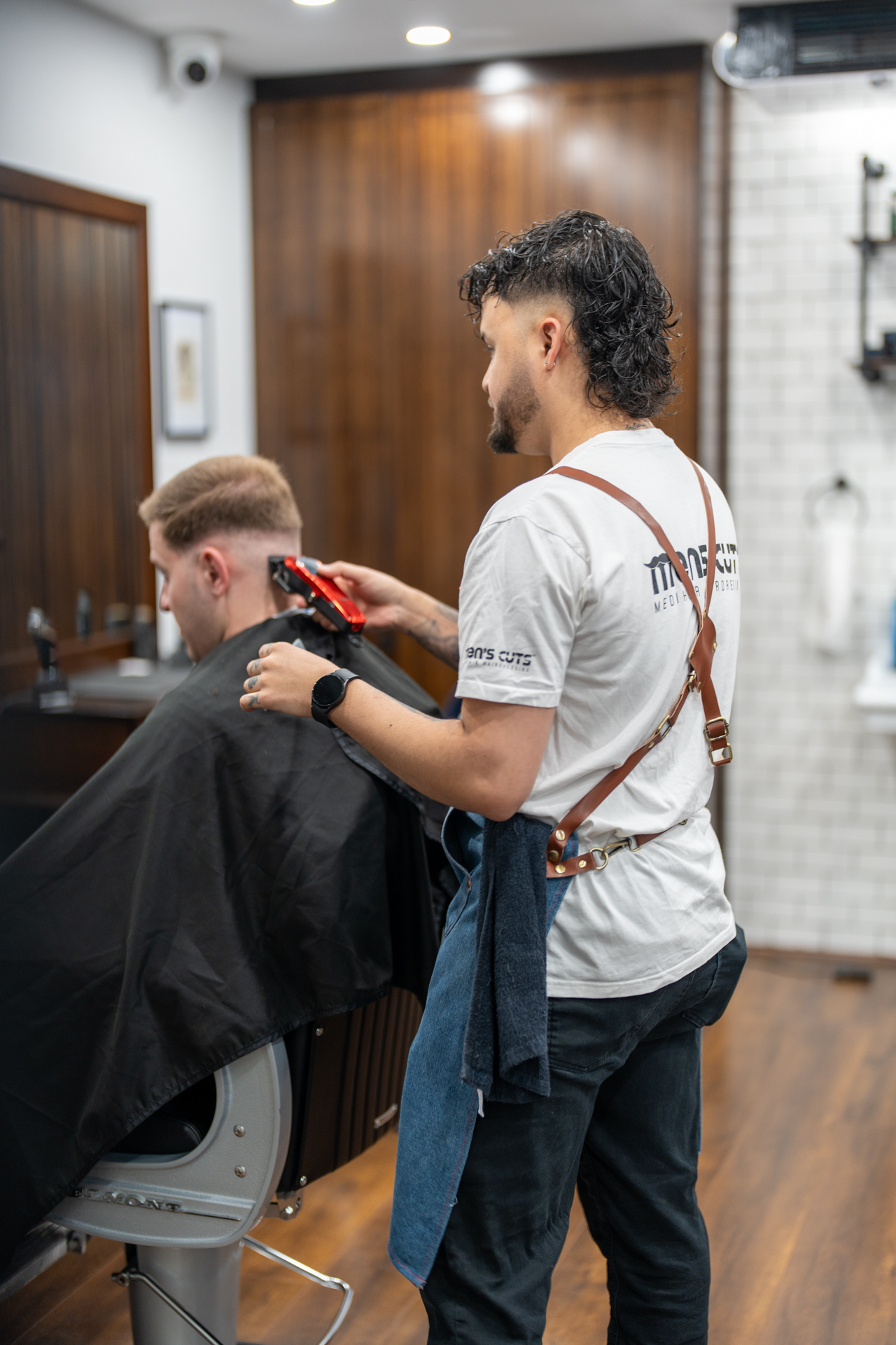 Barber Using Clippers on Client